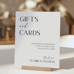 a white card with the words gifts and cards written on it sitting on a table