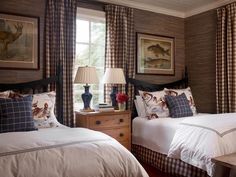 two beds in a room with plaid curtains and lamps on the nightstands next to each other