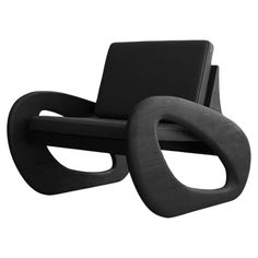 a black chair with an oval shaped seat on it's back legs and arms