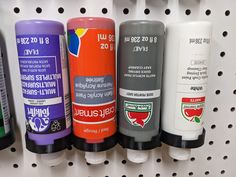 several different colored tubes are lined up on a shelf