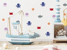 a child's room with an octopus wall decal and a boat in the foreground