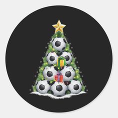 a christmas tree with soccer balls and presents on it's bottom, in front of a black background