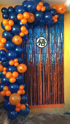 an orange and blue balloon arch in front of a door with chinese characters on it