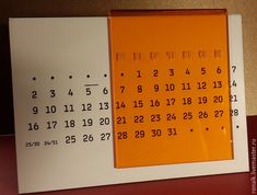 an orange and white calendar with numbers on it