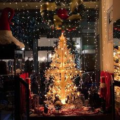 a lighted christmas tree in the middle of a room