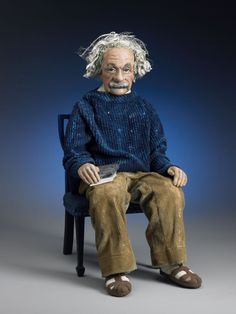 an old man sitting on top of a chair with his legs crossed and hair blowing in the wind