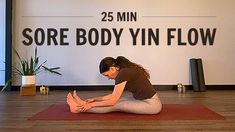 a woman is sitting on the floor doing yoga