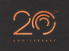 the 20th anniversary logo is shown in gold on black paper, with an orange swirl around it