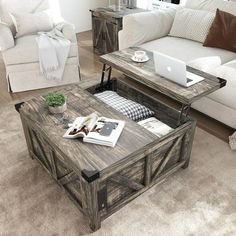 a living room filled with furniture and a laptop computer on top of a coffee table