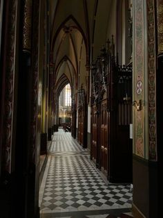 the inside of an old church with black and white checkered flooring on the walls