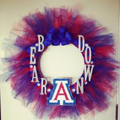 a red, white and blue wreath with the letter a on it's side