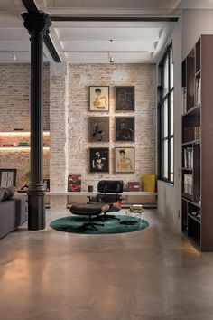 a living room filled with lots of furniture and bookshelves next to a fire place