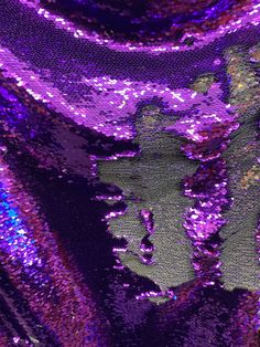 purple and green sequinized fabric with an image of a woman in the center