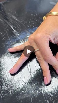 a woman's hand on top of a shiny surface