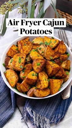 air fryer cajun potatoes in a white bowl with text overlay that reads, air fryer cajun potatoes