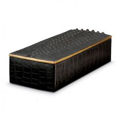 a large black box with gold trimmings on the top and bottom, sitting in front of a white background