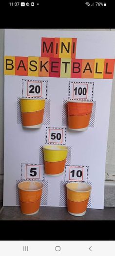 four cups are shown in front of a sign that says mini basket ball on it