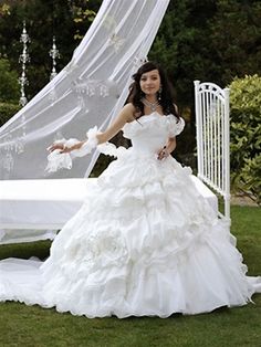 a woman in a white wedding dress posing for the camera