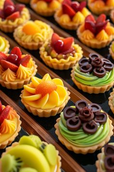 there are many colorful cupcakes on the tray with different toppings in them