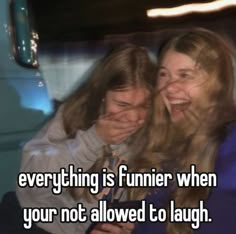 two girls laughing together with the caption everything is funnier when your not allowed to laugh