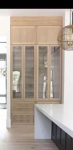 a kitchen with wooden cabinets and white counter tops