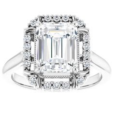 an emerald cut diamond surrounded by white diamonds in a halo setting on a wedding band