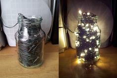 two jars filled with lights sitting on top of a wooden table next to each other