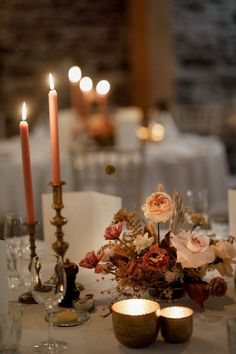 a table with candles and flowers on it