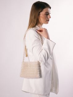 An ivory beaded bag is a versatile accessory that can be dressed up or down, making it suitable for a range of occasions, such as weddings, cocktail parties, or formal events. It can add a touch of elegance and sophistication to any outfit. The bag is roomy, fits a phone 15 cm long and many women's things. The bag is woven from fishing  line, which can withstand 25 kg. It is very reliable as it closes with a magnetic clasp. 100% handmade Material: acrylic pearl beads 8 mm & 12 mm Size:  > width Bridal Purse, Pearl Bag, Satin Bags, Beaded Bag, Cocktail Parties, Wedding Bag, Vintage Bag, Unique Bags, Beaded Top