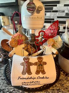 a kitchen counter with a mixer and cookies on it