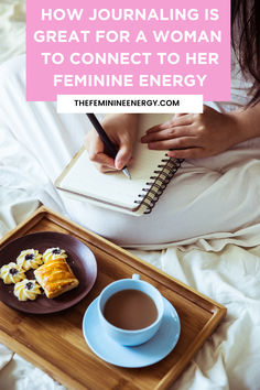 a woman sitting on her bed writing in a notebook with a cup of coffee next to her