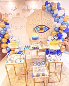 a table topped with cake and balloons in front of a wall