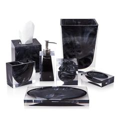 an assortment of black bathroom accessories including soap dispenser, toothbrush holder and tissue dispenser