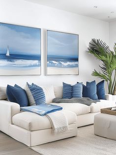 a living room filled with white couches and blue pillows on top of each other