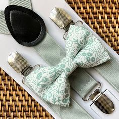 This sage green floral bow tie & sage green suspenders set is a great choice for family photos, groomsmen, wedding, ring bearer outfit, gift, birthday celebration or any other special occasion. ❤ **Please Specify** Bow Tie Only (w/ Clip or Neck Strap), Suspenders Only, or Bow Tie Only & Susp (Bow Tie and Suspenders) SUSPENDERS- One Pair of our Quality Suspenders BOW TIE - One Bow Tie on White Adjustable STRAP or Alligator CLIP **CLIP ON Bow Ties are Recommended/Suitable for Children Only *Sizing Green Bow Tie For Father's Day Gift, Father's Day Gift Green Bow Tie, Green Bow Tie For Wedding And Father's Day, Adjustable Green Bow Tie For Father's Day, Adjustable Green Bow Tie For Wedding, Sage Green Suspenders, Groomsmen Ring, Beach Wedding Groomsmen, Green Suspenders