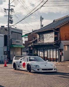 a white car parked in front of a building