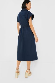 Elegant in its simplicity, the structured and ultra-ladylike Navy Chloe Dress is done in a textured cotton-blend fabric that is sure to turn heads for its design details. The moire pattern throughout and trapunto stitching on the sleeves, placket, and hemline complete this midi moment, making it feel extra special with minimal effort. Pair with heels or flats, sunnies or statement earrings, for day or night, and rest assured that you look fabulous! Spread collar Short wing sleeves Button front p Modern A-line Cotton Dress, Modern Cotton A-line Dress, Modern Structured Midi Dress, Modern Fitted Cotton Dresses, Elegant Cotton Dress With Pleated Waist, Cotton Dresses With Pleated Sleeves For Daywear, Modern Knee-length Cotton Dress, Formal Cotton Dress With Pleated Waist, Cotton Workwear Dress With Pleated Waist