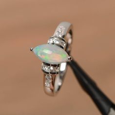 opal engagement ring natural white opal ring October birthstone marquise cut gemstone sterling silve Exclusive Engagement Rings, Elegant Rings, Natural Opal Ring, Opal Engagement Ring, White Opal Ring, Opal Wedding Rings, London Blue Topaz Ring, Opal Engagement, Round Cut Engagement Rings