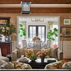 a living room filled with furniture and flowers