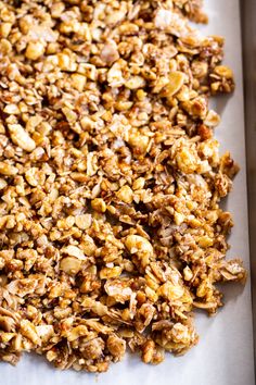 granola on a baking sheet ready to be baked