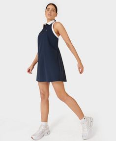 Our new performance dress for days on the court. Sweat-wicking, anti-bacterial fabric keeps you cool and dry. A-line silhouette with pleated skirt and back panel. Ribbed collar with quarter zip. Front length: 87cm / 34". Model wears size S and is 178cm/5'10" tall. Style Code: SB9289Colour: Navy Blue Summer Sports Pleated Tennis Dress, Summer Sports Tennis Dress With Pleats, Sporty Pleated Tennis Dress For Summer, Sporty Moisture-wicking Dresses For Spring, Athleisure Mini Tennis Dress, Casual Sleeveless Moisture-wicking Dress, Casual Pleated Sleeveless Tennis Dress, Casual Sleeveless Tennis Dress, Pleated Tennis Dress