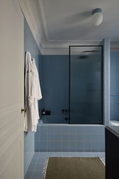 a bathroom with blue tiles and white towels