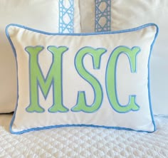 a close up of a pillow on a bed with the word mssc painted on it