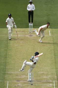 the men are playing a game of cricket on the field