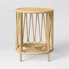 the side table is made out of wicker and has a circular design on it