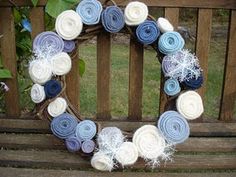 a wreath made out of yarn sitting on top of a wooden bench