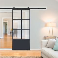 a living room filled with furniture and a sliding glass door that leads to a dining area