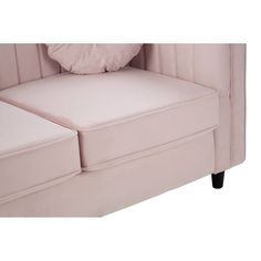 the back end of a pink couch with two pillows on it's armrests