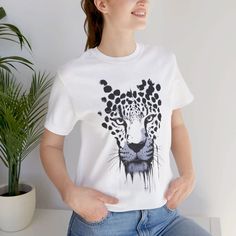 Embrace your wild side with this stunning "Snow Leopard Shirt." Perfect for animal lovers and fashion enthusiasts alike, this "Leopard Shirt" features a vibrant and colorful design that makes it stand out in any crowd. Whether you're at a concert or just hanging out with friends, this "Leopard TShirt" brings a touch of the wild to your wardrobe. The "Cheetah Shirts" trend is hotter than ever, and this "Big Cat Tee" fits right in with its trendy and stylish look. Ideal for those who love bold, eye-catching designs, this "Colorful Snow Leopard Tshirt" is a must-have for your collection. **Product Details - 100% Airlume combed and ringspun cotton (fiber content may vary for different colors) - Light fabric (4.2 oz/yd² (142 g/m - Retail fit - Tear away label - Runs true to size **Care Instruct Shirts Trendy, Leopard Shirt, Cat Tee, Big Cat, Concert Tshirts, Snow Leopard, Colorful Design, Trendy Tshirts, Animal Lovers