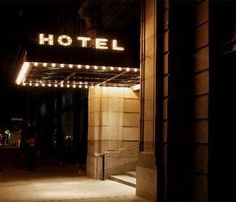 the hotel sign is lit up at night